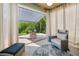 Relaxing patio with a cozy seating area and a shaded awning overlooking the beautiful green backyard at 8778 Peachtree Park Ct, Windermere, FL 34786