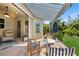 Covered patio with comfortable seating, a ceiling fan, and a beautiful view of the landscaped backyard at 8778 Peachtree Park Ct, Windermere, FL 34786
