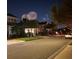 Night shot of a neighborhood street with houses and celebratory fireworks in the background at 8778 Peachtree Park Ct, Windermere, FL 34786