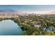 Aerial view of waterfront homes surrounded by lush trees and a skyline in the background at 919 Boardman St, Orlando, FL 32804