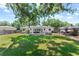 This backyard features a gazebo, hot tub, lush lawn, and mature trees offering privacy and shade at 919 Boardman St, Orlando, FL 32804