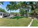 Expansive backyard featuring a lush green lawn, mature trees, a gazebo, and a private hot tub at 919 Boardman St, Orlando, FL 32804