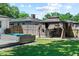 This backyard features a gazebo perfect for outdoor entertaining, a hot tub and lush green lawn at 919 Boardman St, Orlando, FL 32804