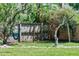 The backyard is fully fenced and includes mature trees, flowering plants and a blue hammock at 919 Boardman St, Orlando, FL 32804