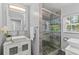 Modern bathroom with walk-in shower, mosaic tile accents, and vessel sink at 919 Boardman St, Orlando, FL 32804
