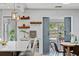 Dining room near kitchen has stylish lighting, decor shelving and looks out to the bright sun room at 919 Boardman St, Orlando, FL 32804