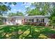 Charming home featuring a well-manicured lawn, inviting red door, and a two-car garage, exuding classic curb appeal at 919 Boardman St, Orlando, FL 32804