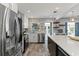 Open kitchen boasts stainless appliances, white cabinets, tile backsplash, and a center island for meal prep at 919 Boardman St, Orlando, FL 32804