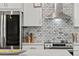 Modern kitchen features stainless appliances, white cabinets, marble backsplash, and lots of counter space at 919 Boardman St, Orlando, FL 32804