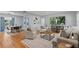Open living space with wood floors, neutral tones, and large TV, perfect for modern living at 919 Boardman St, Orlando, FL 32804