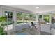 Bright sunroom with many windows, wood floors, and backyard view at 919 Boardman St, Orlando, FL 32804