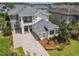An aerial view shows the home with well-maintained lawn, paver driveway, and other homes in the neighborhood at 9421 Dugard Ct, Orlando, FL 32827