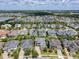 An aerial view of the neighborhood shows many homes, green lawns, and nearby lakes and trees at 9421 Dugard Ct, Orlando, FL 32827