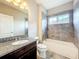 Bathroom with granite vanity, new toilet, and tiled shower and tub at 9421 Dugard Ct, Orlando, FL 32827
