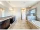Spacious bathroom featuring a soaking tub, glass shower, and double sink vanity with granite counters at 9421 Dugard Ct, Orlando, FL 32827