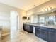 Granite countertops, dual sinks, and dark cabinets in the bathroom with tile flooring and open layout at 9421 Dugard Ct, Orlando, FL 32827
