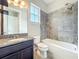 Bathroom with granite vanity, new toilet, and tiled shower and tub at 9421 Dugard Ct, Orlando, FL 32827