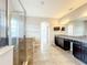 Bathroom featuring a glass-enclosed shower, granite countertops, dark cabinets, and tile floors at 9421 Dugard Ct, Orlando, FL 32827
