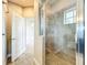 Modern bathroom boasts tiled shower with glass door and neutral color palette for a relaxing atmosphere at 9421 Dugard Ct, Orlando, FL 32827