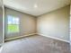 Bright bedroom features neutral carpeting and ample natural light from a large window at 9421 Dugard Ct, Orlando, FL 32827