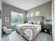 Cozy bedroom with a large window, neutral color scheme, and comfortable furnishings for relaxation at 9421 Dugard Ct, Orlando, FL 32827
