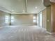 Bright, carpeted bedroom with ample natural light, featuring tray ceilings, and neutral tones at 9421 Dugard Ct, Orlando, FL 32827