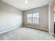 Cozy bedroom features neutral carpeting and ample natural light from a large window at 9421 Dugard Ct, Orlando, FL 32827