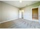 Bright bedroom with neutral carpet, fresh paint and a door to another room at 9421 Dugard Ct, Orlando, FL 32827