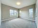 Well-lit bedroom features neutral carpet, and large windows offering plenty of natural light at 9421 Dugard Ct, Orlando, FL 32827