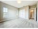 Bright bedroom with double doors, neutral carpet, and large windows offering plenty of natural light at 9421 Dugard Ct, Orlando, FL 32827