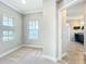 Bright bedroom with large windows and a view of the bathroom that has dark granite countertops at 9421 Dugard Ct, Orlando, FL 32827