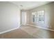 Bright bedroom with neutral carpet, a large window, and fresh paint at 9421 Dugard Ct, Orlando, FL 32827