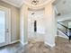 Open foyer with tile flooring, archways, and a staircase, creating an elegant entry to the home at 9421 Dugard Ct, Orlando, FL 32827
