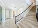 Welcoming foyer with tile flooring and staircase access with views of the other open-concept living spaces at 9421 Dugard Ct, Orlando, FL 32827