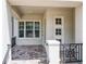 A covered front porch with tile flooring and black iron railings, offering a welcoming entrance at 9421 Dugard Ct, Orlando, FL 32827