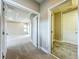 Hallway featuring open doorways to a bedroom with tray ceiling and a bathroom at 9421 Dugard Ct, Orlando, FL 32827