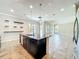 Open kitchen with granite island, stainless steel appliances, and seamless flow to the living area at 9421 Dugard Ct, Orlando, FL 32827