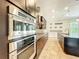 Modern kitchen with stainless steel appliances, built-in oven, and stylish cabinetry at 9421 Dugard Ct, Orlando, FL 32827
