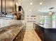 Gourmet kitchen with granite countertops, stainless steel appliances, and dark wood cabinetry at 9421 Dugard Ct, Orlando, FL 32827