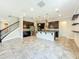 Open-concept kitchen featuring dark cabinets, stainless steel appliances, an island with seating, and stylish pendant lighting at 9421 Dugard Ct, Orlando, FL 32827