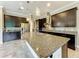 Spacious kitchen island with granite countertop, stainless steel sink, and ample storage at 9421 Dugard Ct, Orlando, FL 32827