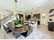 Open-concept kitchen with dark wood cabinets, granite countertops, and a dining area at 9421 Dugard Ct, Orlando, FL 32827