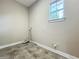 Functional laundry room with tile flooring, hookups for washer and dryer, and a window for natural light at 9421 Dugard Ct, Orlando, FL 32827