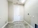 Functional laundry room offering essential utility connections and tiled flooring for easy maintenance at 9421 Dugard Ct, Orlando, FL 32827