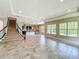 Spacious living room featuring tile flooring, staircase, and an open layout to the kitchen area at 9421 Dugard Ct, Orlando, FL 32827