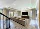Comfortable living room with plush seating, a large TV, and abundant natural light at 9421 Dugard Ct, Orlando, FL 32827