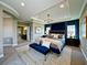 Luxurious main bedroom with tray ceilings, a king bed, and accent lighting; elegant and spacious at 9421 Dugard Ct, Orlando, FL 32827
