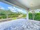 Open-air patio featuring stone pavers and serene views of manicured landscaping and nearby residences, perfect for outdoor enjoyment at 9421 Dugard Ct, Orlando, FL 32827