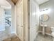 Convenient powder room with pedestal sink, round mirror, and modern fixtures at 9421 Dugard Ct, Orlando, FL 32827