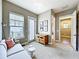 Comfortable sitting room featuring neutral color palette and lots of natural light from the adjacent balcony at 9421 Dugard Ct, Orlando, FL 32827
